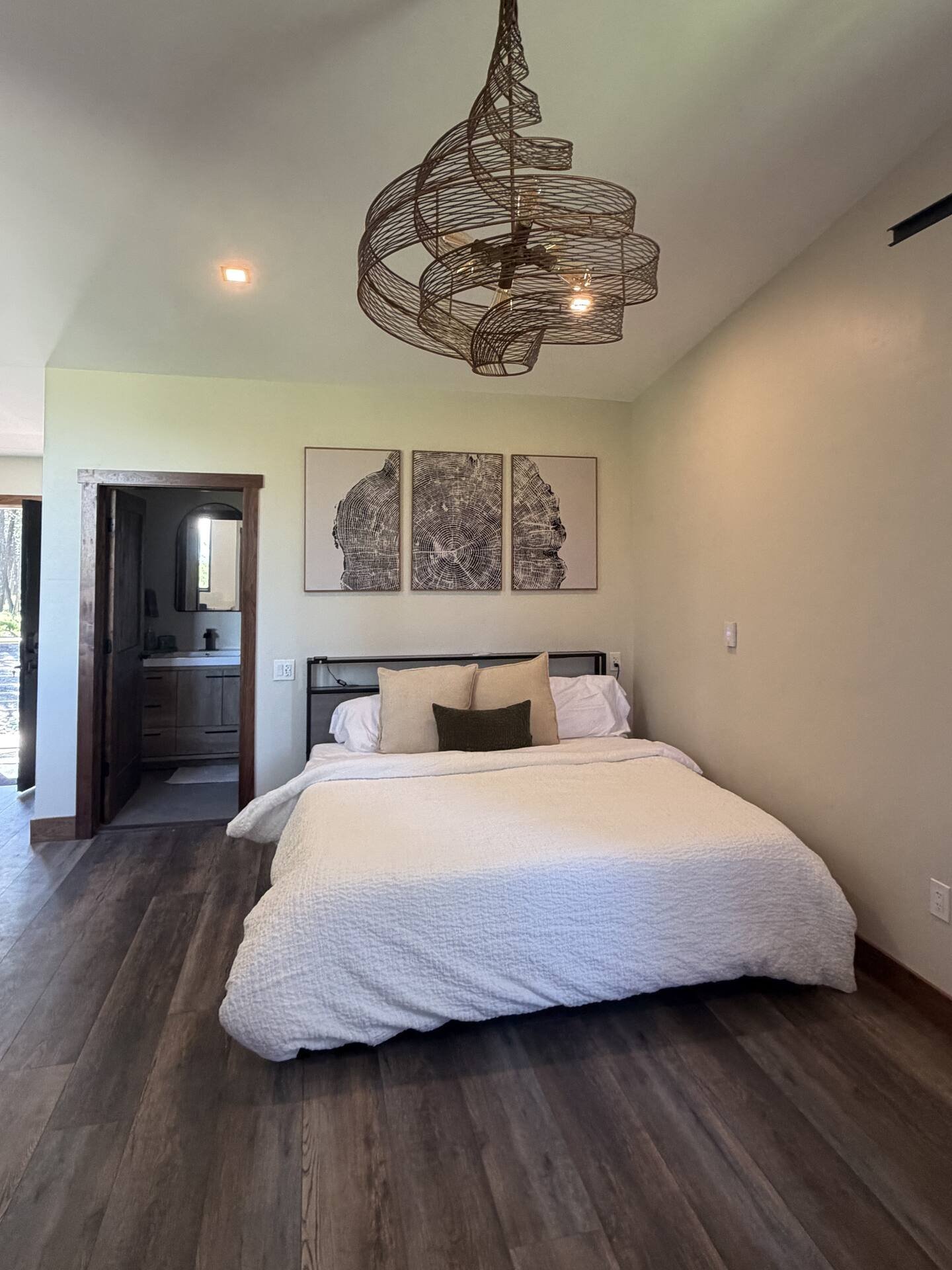 King bed at The Ridge with walnut trim and forest outlook