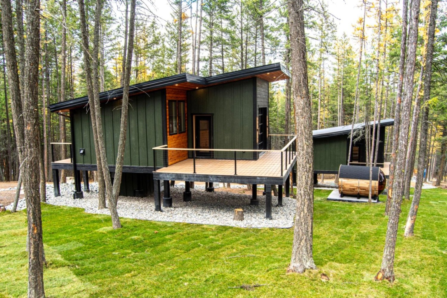 The Summit on stilts with a wood-clad hot tub alongside the deck