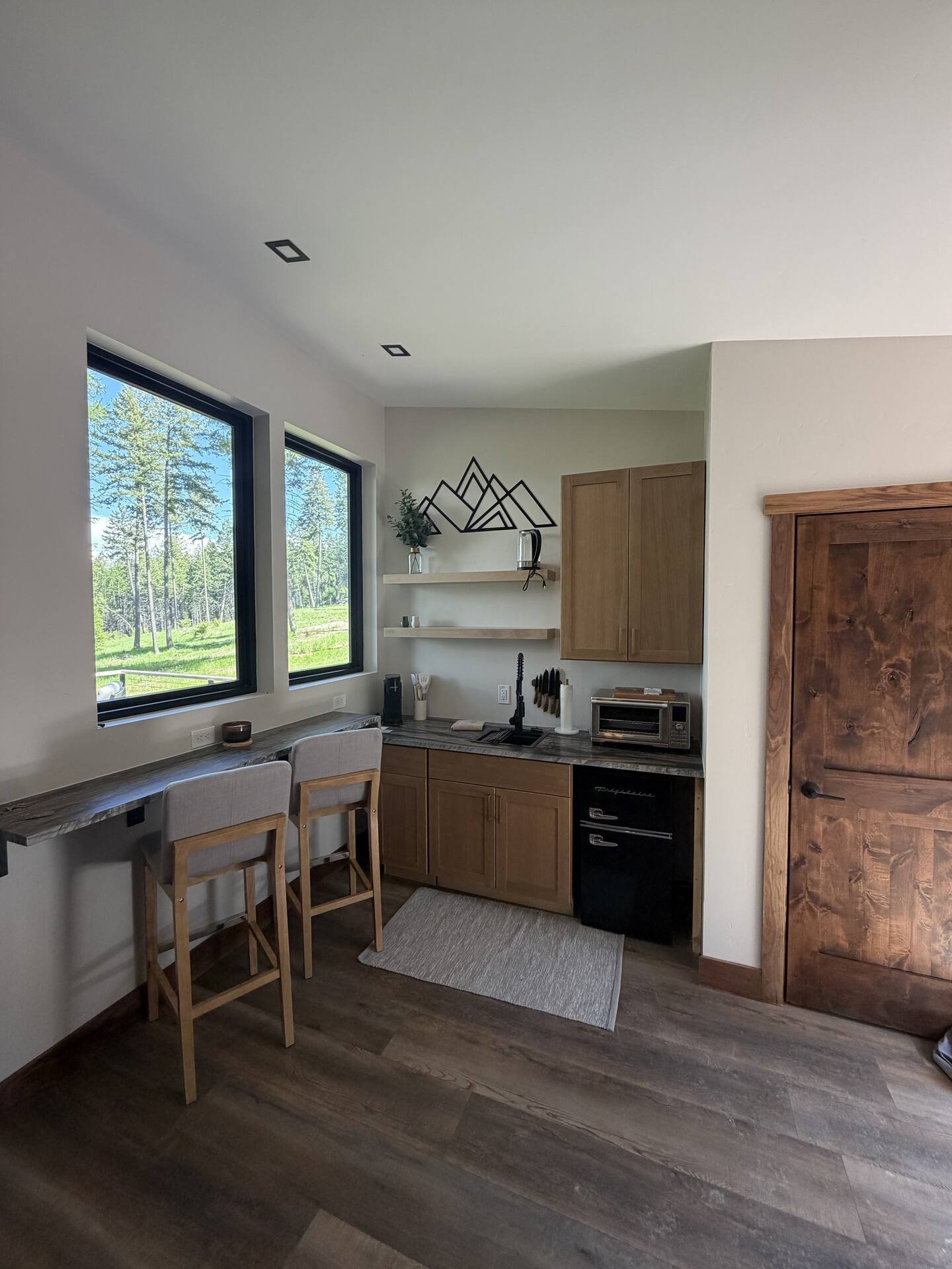 Kitchenette at The Summit with quartzite countertops and walnut trim
